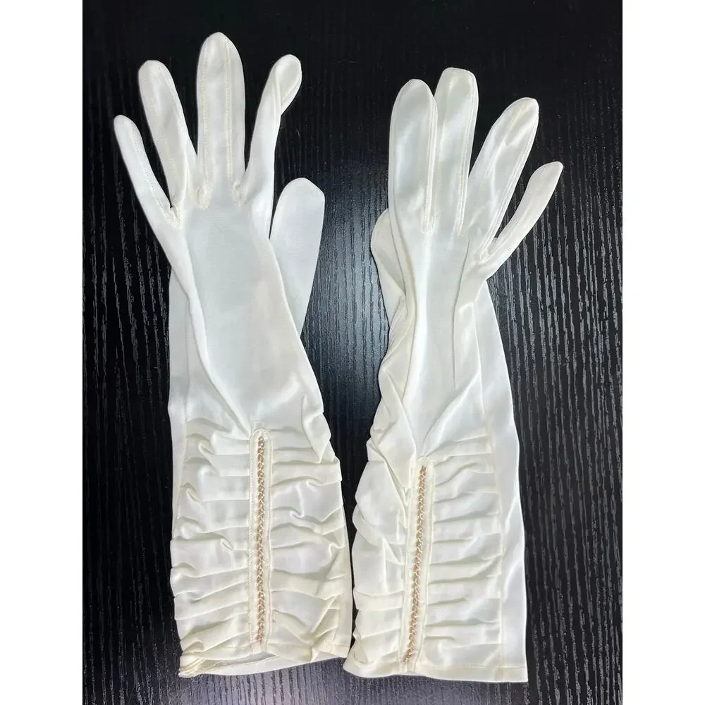 Vintage 60's era elegant long dress gloves tagged with faux pearl accents